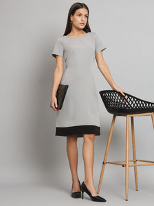 Stretch color blocked grey dress with black hem and elegant accessories.