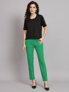 Comfort Fit Round Neck Top in black, paired with green trousers.