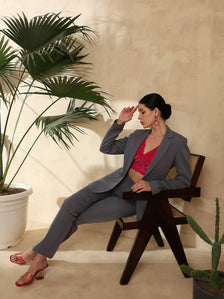 Model in dark grey stretch pant suit with pink lace top.