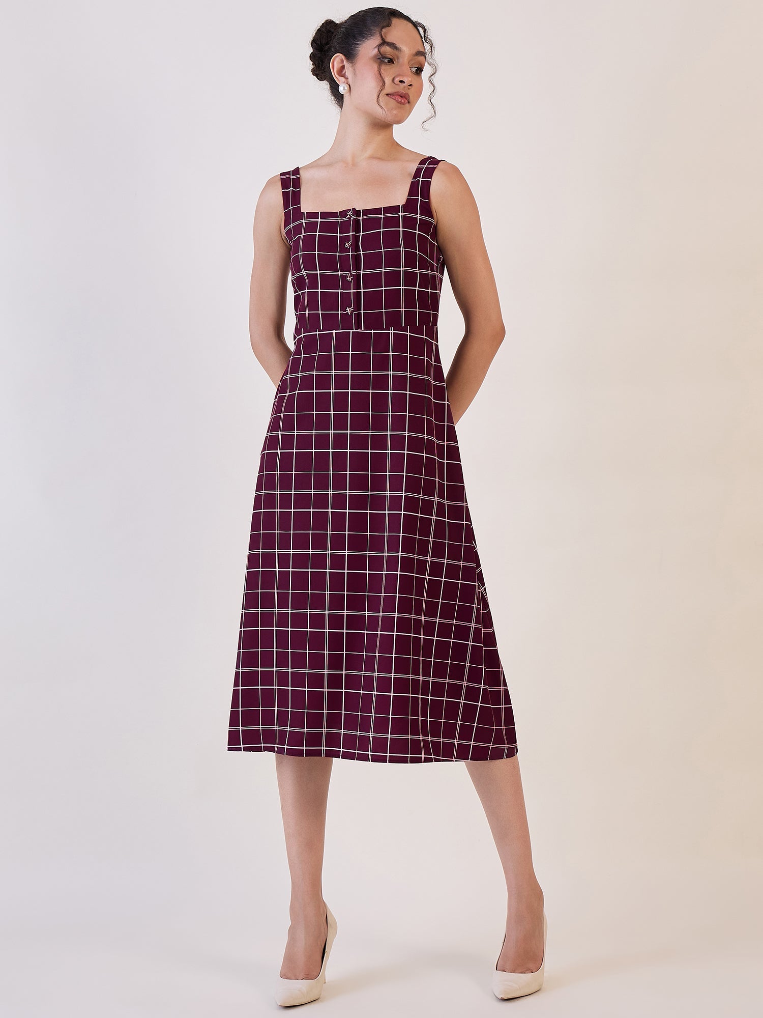 Maroon check fit and flare dress with square neckline and buttons.