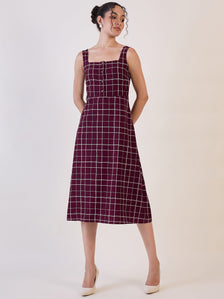 Maroon check fit and flare dress with square neckline and buttons.