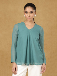 Green A-line top with long sleeves and V-neck design.