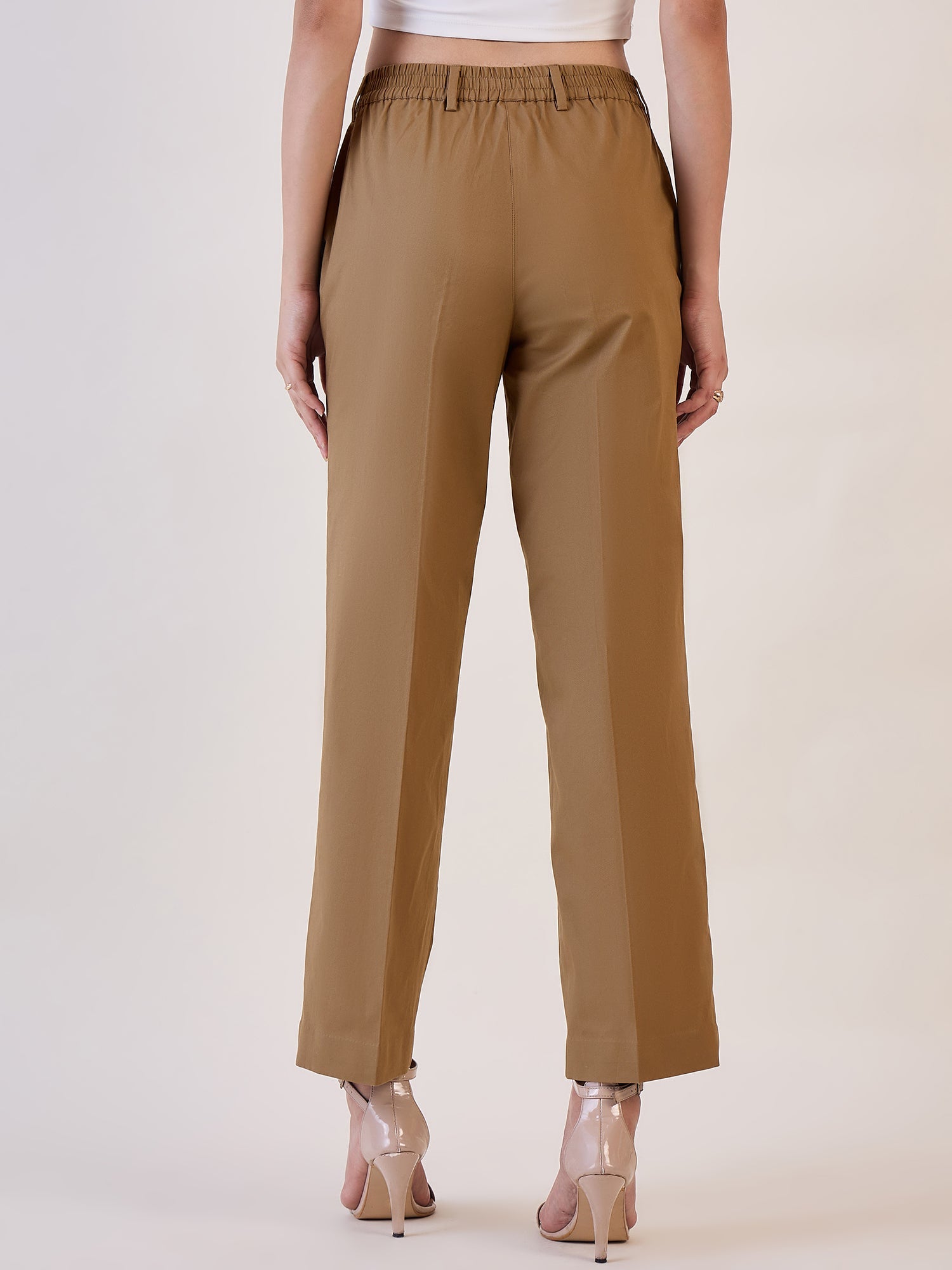 Brown straight fit mid waist trouser back view on model.