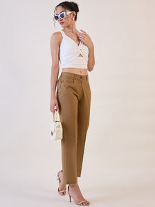 Brown straight fit mid waist trousers styled with a white top.