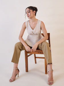 Model wearing camel brown straight fit mid waist trousers, styled elegantly.