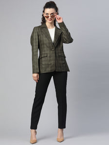 Checkered tweed jacket in bottle green worn with stylish sunglasses.